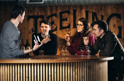 3 people tasting whiskey with barman